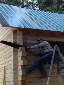 Given A Gift ~ Mountain Man sawing the ends off the cabin